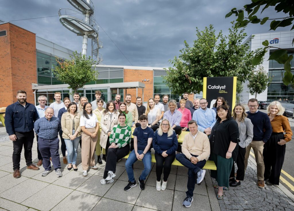 Team photo of the Catalyst Team standing in front of the Innovation Centre in Belfast. 